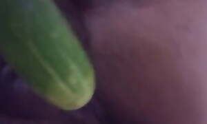 Wife plays with cucumber